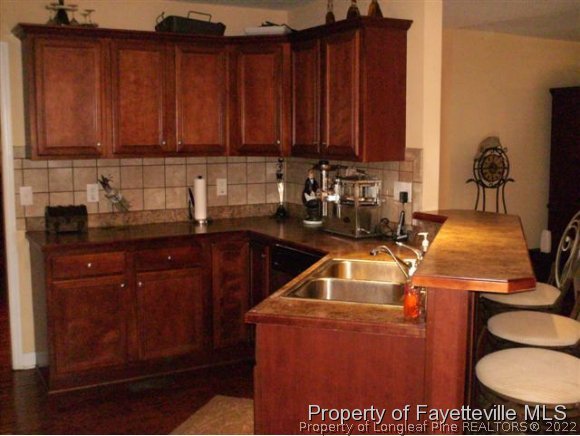 211 Booth Pond Road Raeford, NC 28376 - Photo 11 of 25 a kitchen with a sink and cabinets