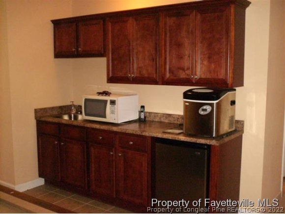 211 Booth Pond Road Raeford, NC 28376 - Photo 16 of 25 a kitchen with stainless steel appliances granite countertop a sink stove and cabinets