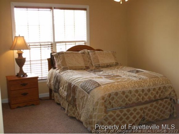 211 Booth Pond Road Raeford, NC 28376 - Photo 20 of 25 a bed sitting in a bedroom next to a window