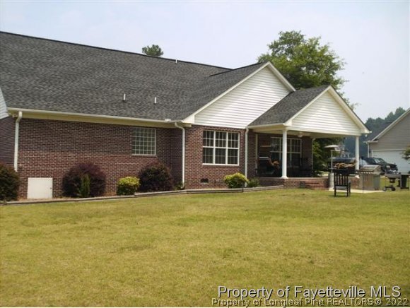 211 Booth Pond Road Raeford, NC 28376 - Photo 21 of 25 a view of a house with a yard and sitting area