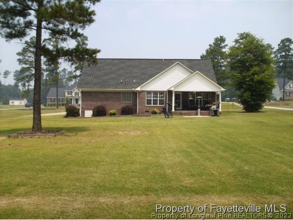 211 Booth Pond Road Raeford, NC 28376 - Photo 22 of 25 a view of a house with yard and lake view