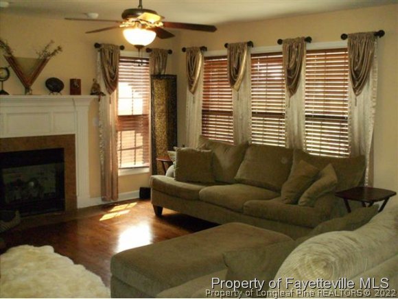 211 Booth Pond Road Raeford, NC 28376 - Photo 5 of 25 a living room with furniture and a fireplace