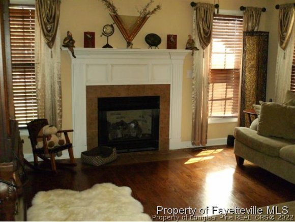 211 Booth Pond Road Raeford, NC 28376 - Photo 6 of 25 a living room with furniture a window and a fireplace