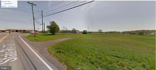 a view of a field with an ocean