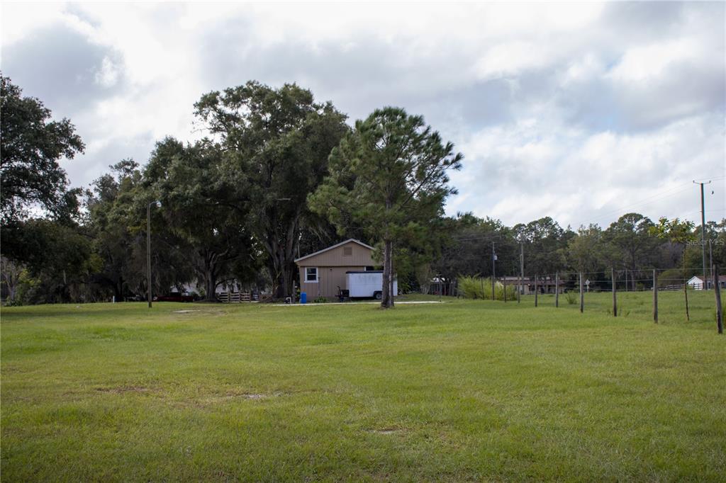 6130 Fussell Road Polk City, FL 33868 - Photo 13 of 21 a view of a green field with trees in the background