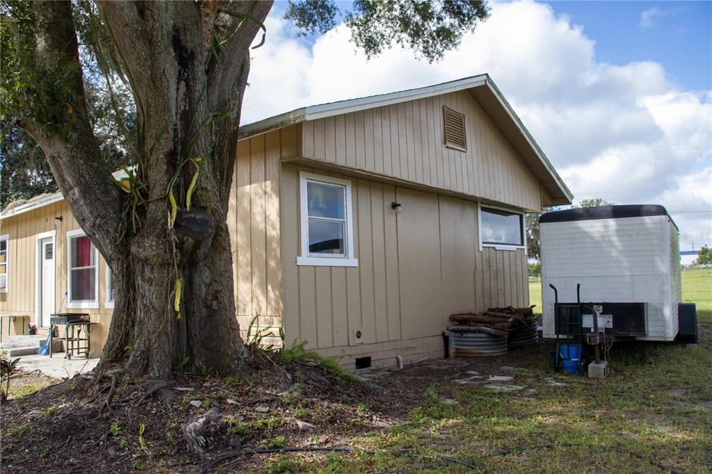 6130 Fussell Road Polk City, FL 33868 - Photo 15 of 21 a backyard of a house with yard and garage