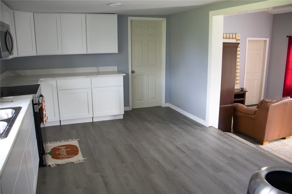 6130 Fussell Road Polk City, FL 33868 - Photo 3 of 21 a view of kitchen with wooden floor
