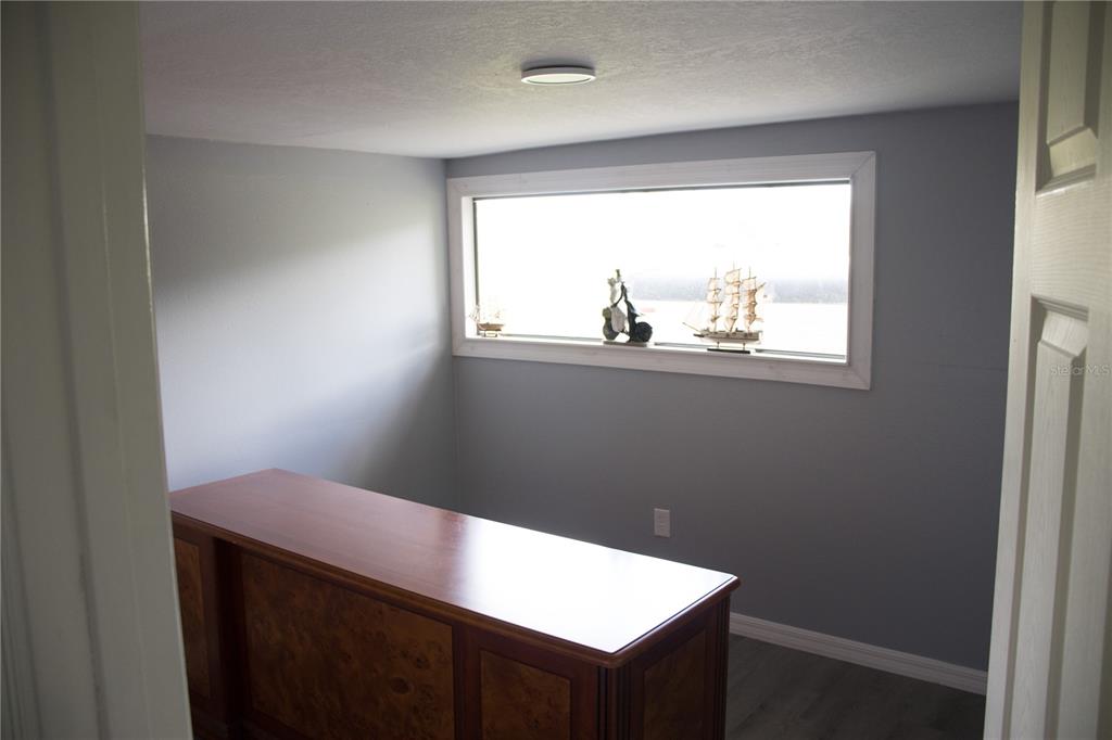 6130 Fussell Road Polk City, FL 33868 - Photo 6 of 21 a view of a small space with wooden floor and a window