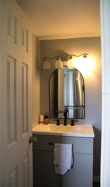 6130 Fussell Road Polk City, FL 33868 - Photo 10 of 21 a bathroom with a sink and a mirror