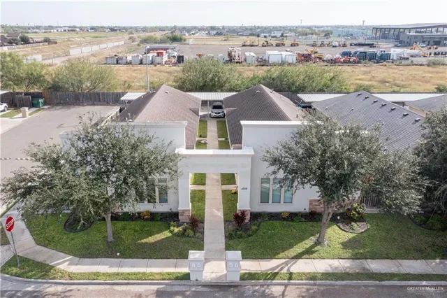 an aerial view of a house with a yard and lake view