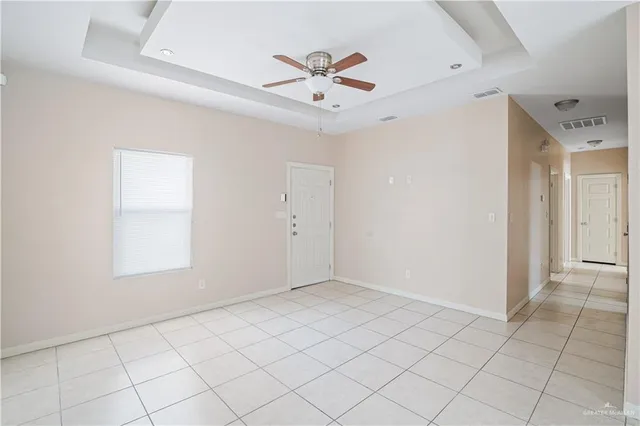 an empty room with fan and windows