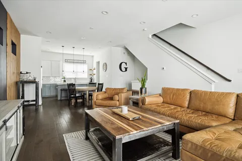 a living room with furniture and view of kitchen