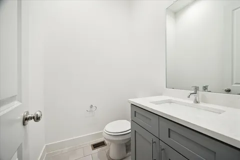 a bathroom with a sink a toilet and mirror