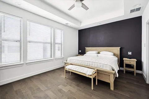 a bed sitting in a bedroom next to a window