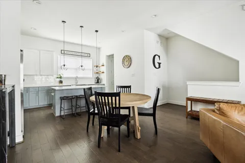 a dining room with furniture and wooden floor