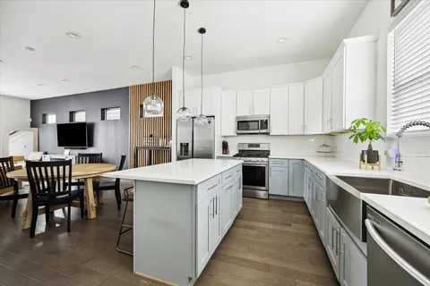 a kitchen with kitchen island granite countertop counter top space a sink appliances and cabinets