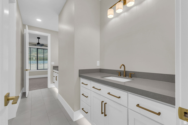 2828 Jojo Road Eagle Mountain, UT 84005 - Photo 31 of 63 Vanity with a rectangular undermount sink, a bronze-finish faucet, and coordinating hardware on white cabinetry