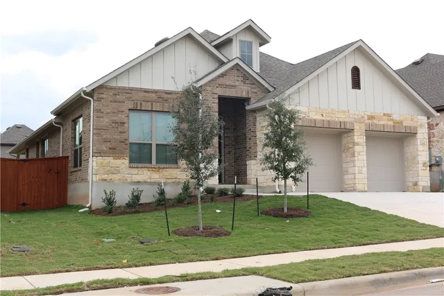 a view of a yard in front view of a house