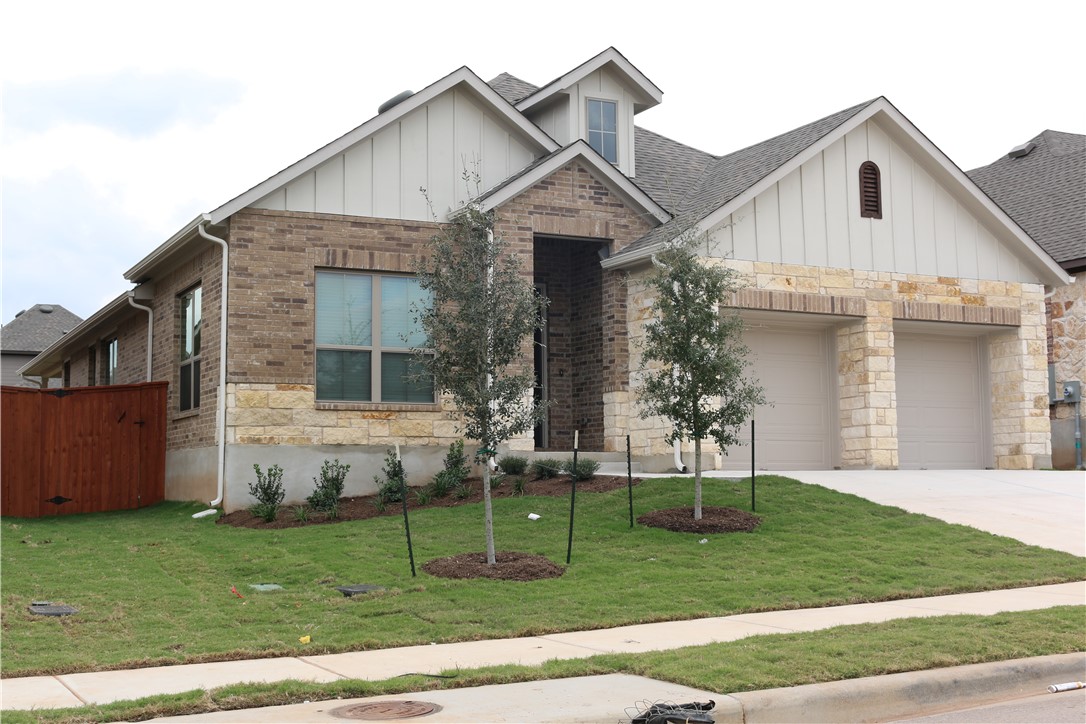 a view of a yard in front view of a house
