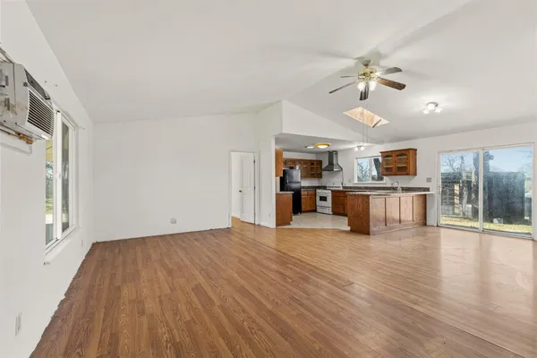 a view of kitchen with granite countertop cabinets and refrigerator