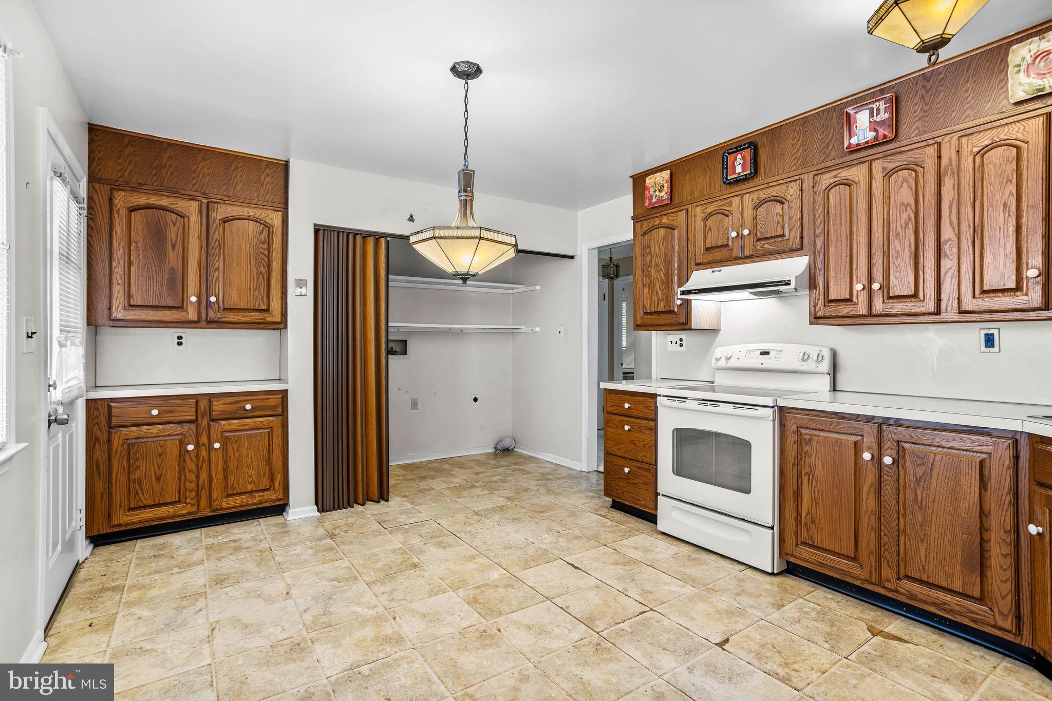 253 Saxer Avenue Springfield, PA 19064 - Photo 11 of 25 a kitchen with stainless steel appliances granite countertop a stove sink and cabinets