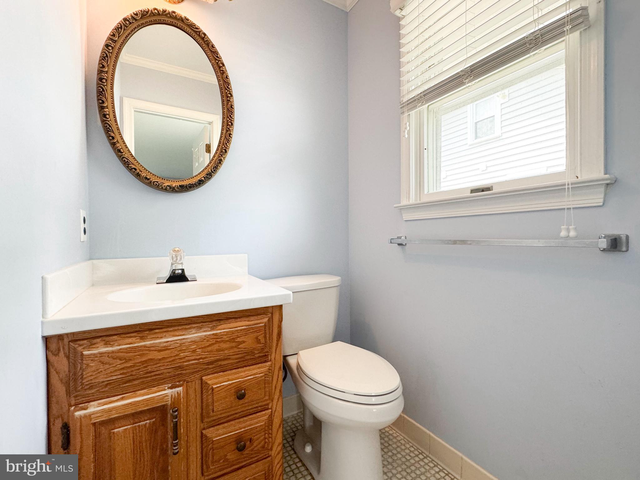 253 Saxer Avenue Springfield, PA 19064 - Photo 14 of 25 a bathroom with a sink a mirror and a toilet