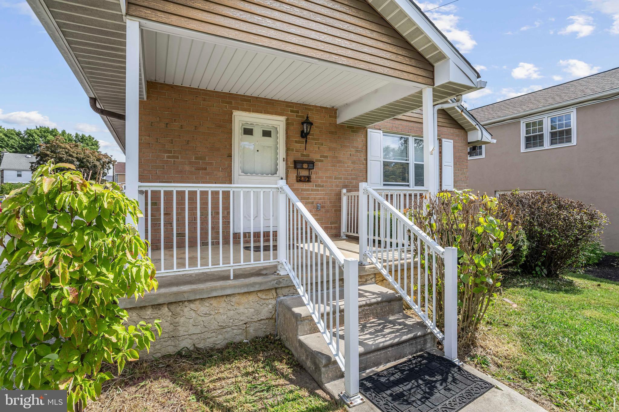 253 Saxer Avenue Springfield, PA 19064 - Photo 3 of 25 a view of a house with a small yard and wooden fence