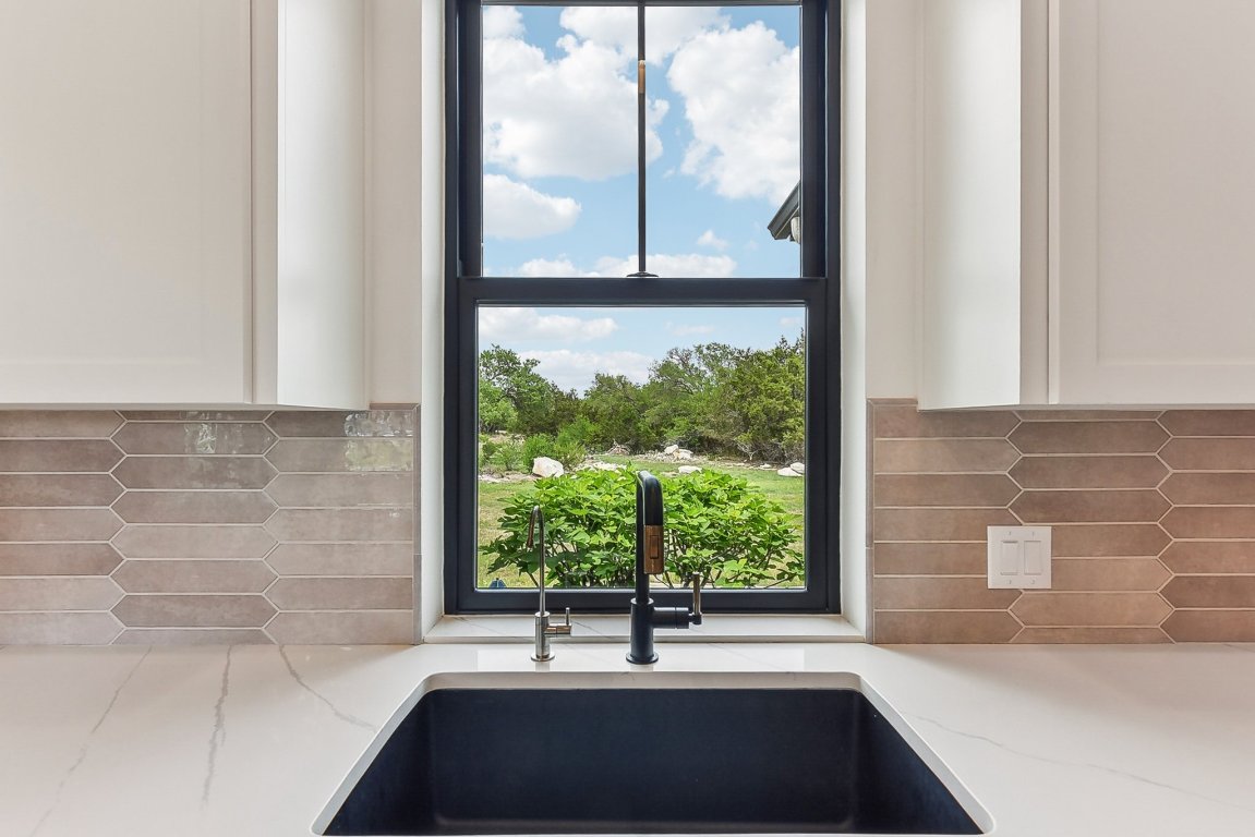 116 Tranquility Trail Spicewood, TX 78669 - Photo 18 of 40 a bathroom with a bathtub and a window