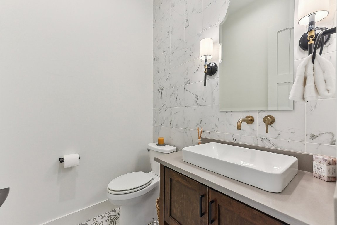 116 Tranquility Trail Spicewood, TX 78669 - Photo 19 of 40 a bathroom with a sink a toilet and mirror
