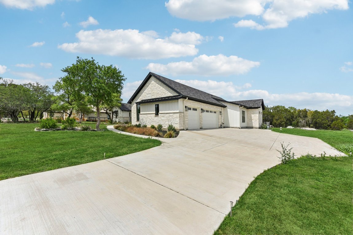116 Tranquility Trail Spicewood, TX 78669 - Photo 2 of 40 a front view of house with yard and green space