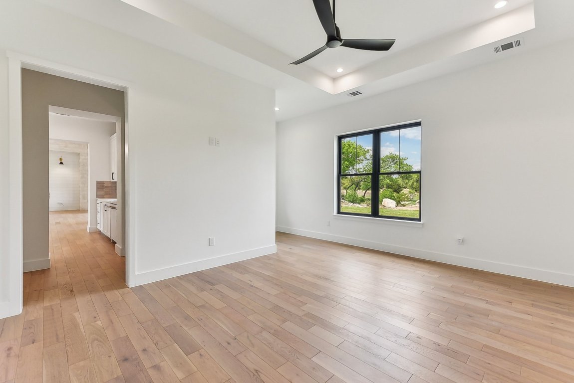 116 Tranquility Trail Spicewood, TX 78669 - Photo 21 of 40 wooden floor in an empty room with a window