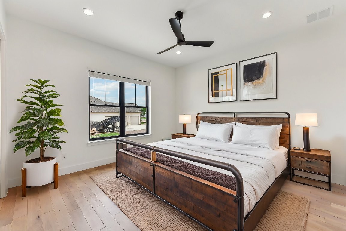 116 Tranquility Trail Spicewood, TX 78669 - Photo 28 of 40 a bedroom with bed and a window