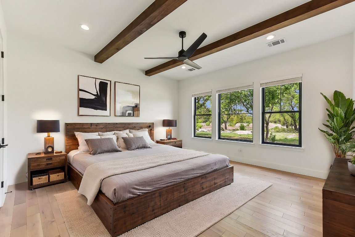 116 Tranquility Trail Spicewood, TX 78669 - Photo 31 of 40 a bedroom with a large bed and a tv