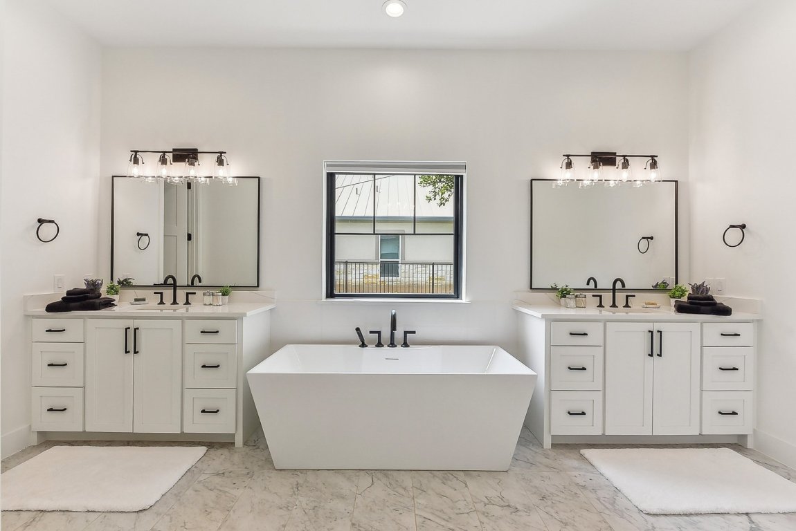 116 Tranquility Trail Spicewood, TX 78669 - Photo 32 of 40 a bathroom with a double vanity sink mirror and bathtub