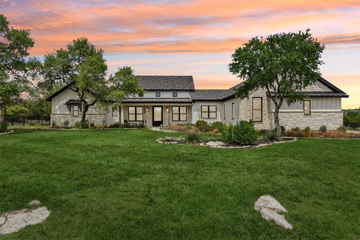116 Tranquility Trail Spicewood, TX 78669 - Photo 6 of 40 a front view of house with yard and green space