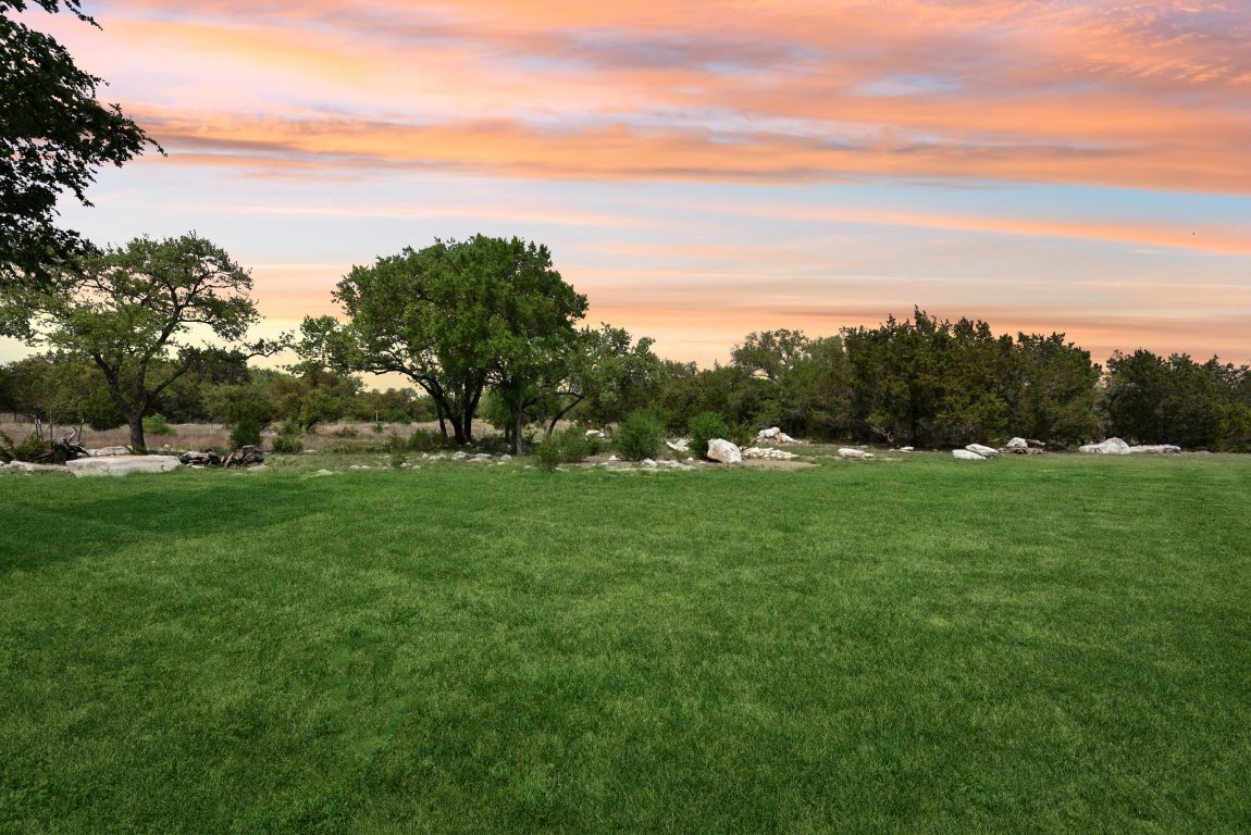 116 Tranquility Trail Spicewood, TX 78669 - Photo 7 of 40 a view of a green field with covered in the background