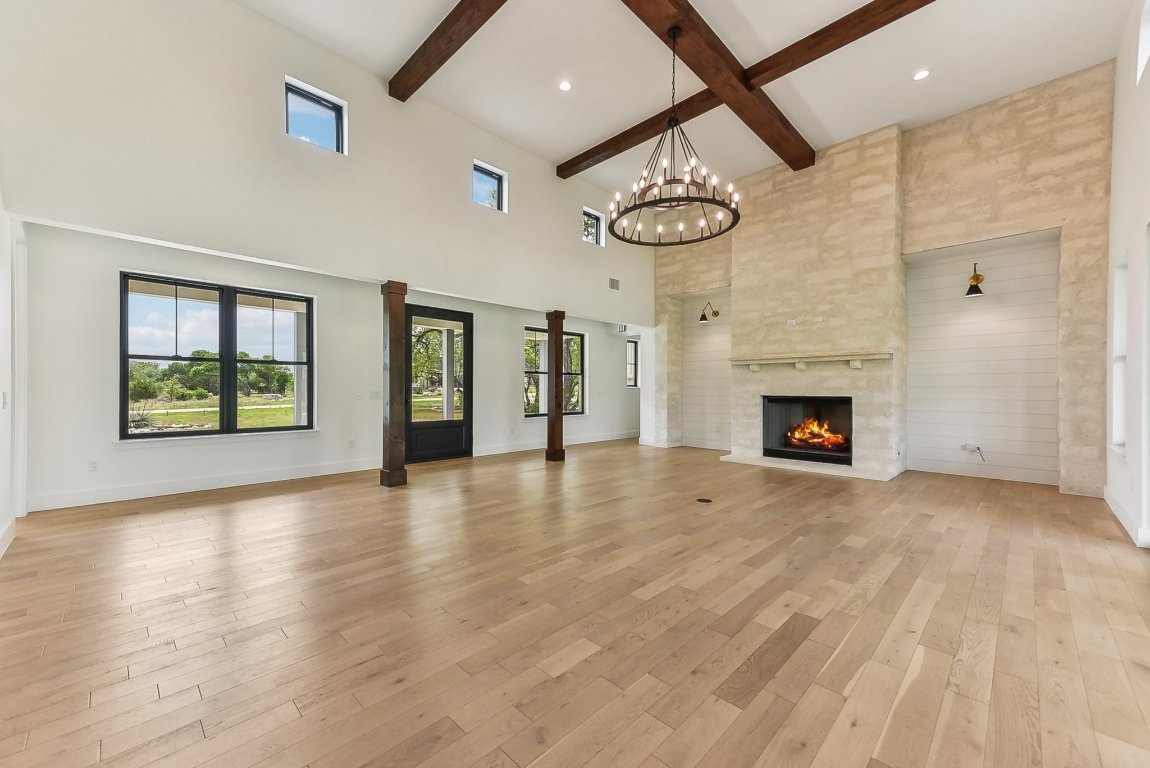 116 Tranquility Trail Spicewood, TX 78669 - Photo 8 of 40 a view of an empty room with wooden floor and a window