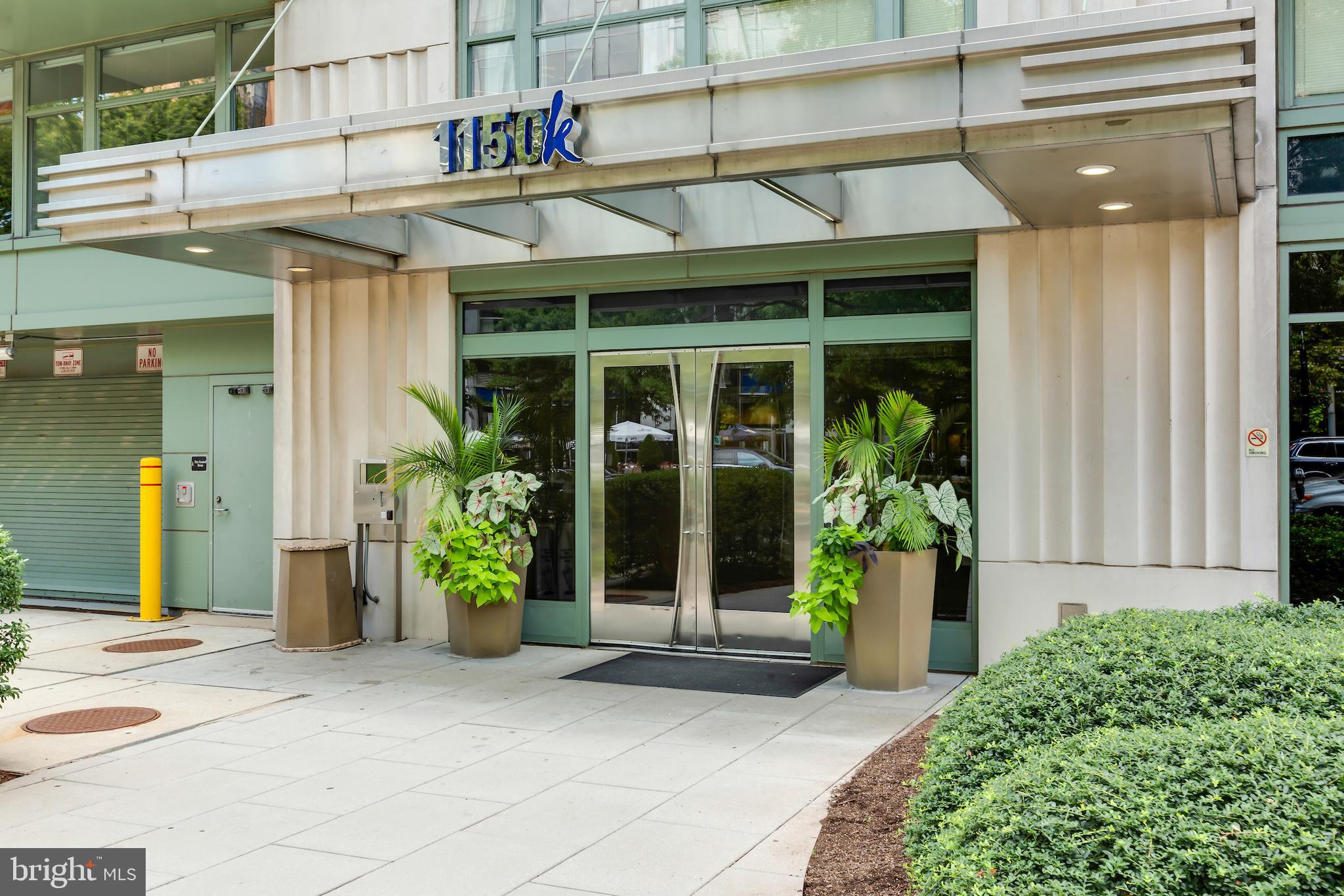 a view of a house with potted plants