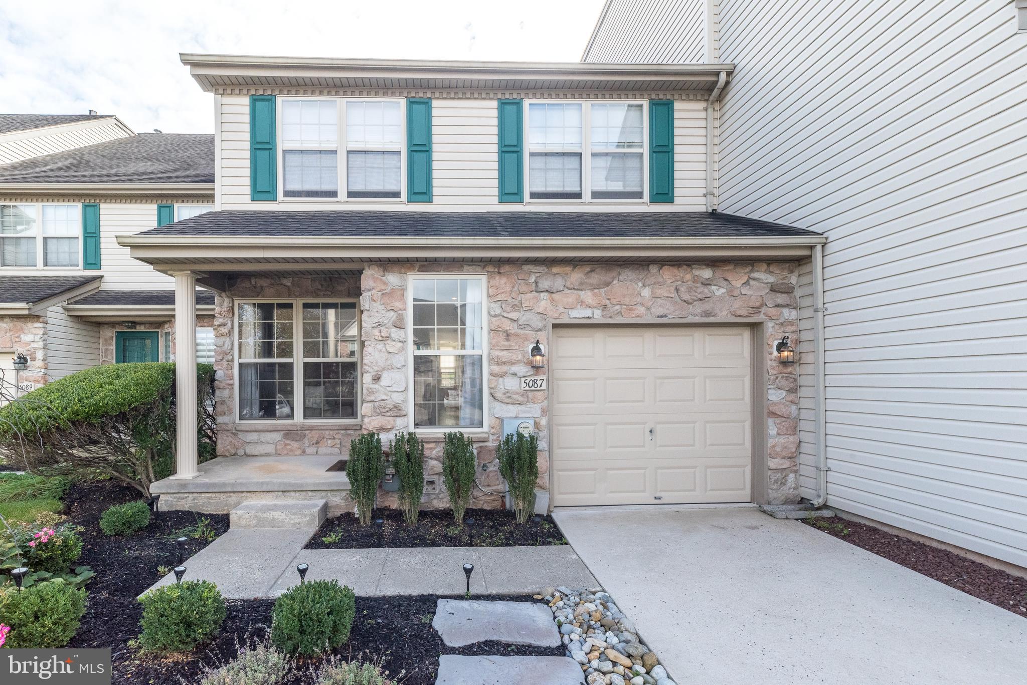 5087 Beacon Hill Court Doylestown, PA 18902 - Photo 1 of 28 a front view of a house with a yard and garage