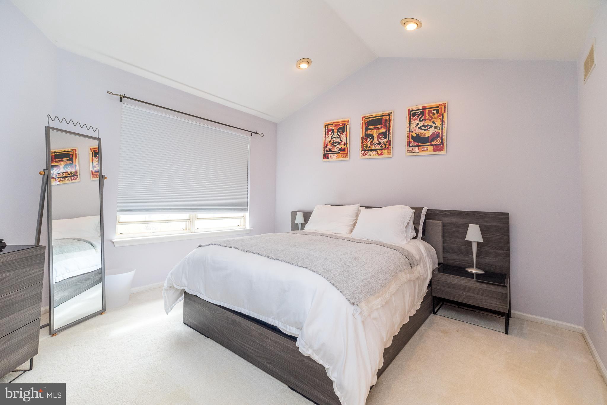 5087 Beacon Hill Court Doylestown, PA 18902 - Photo 16 of 28 a spacious bedroom with a bed and a large mirror