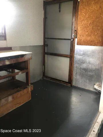 a room with water heater and a wooden door