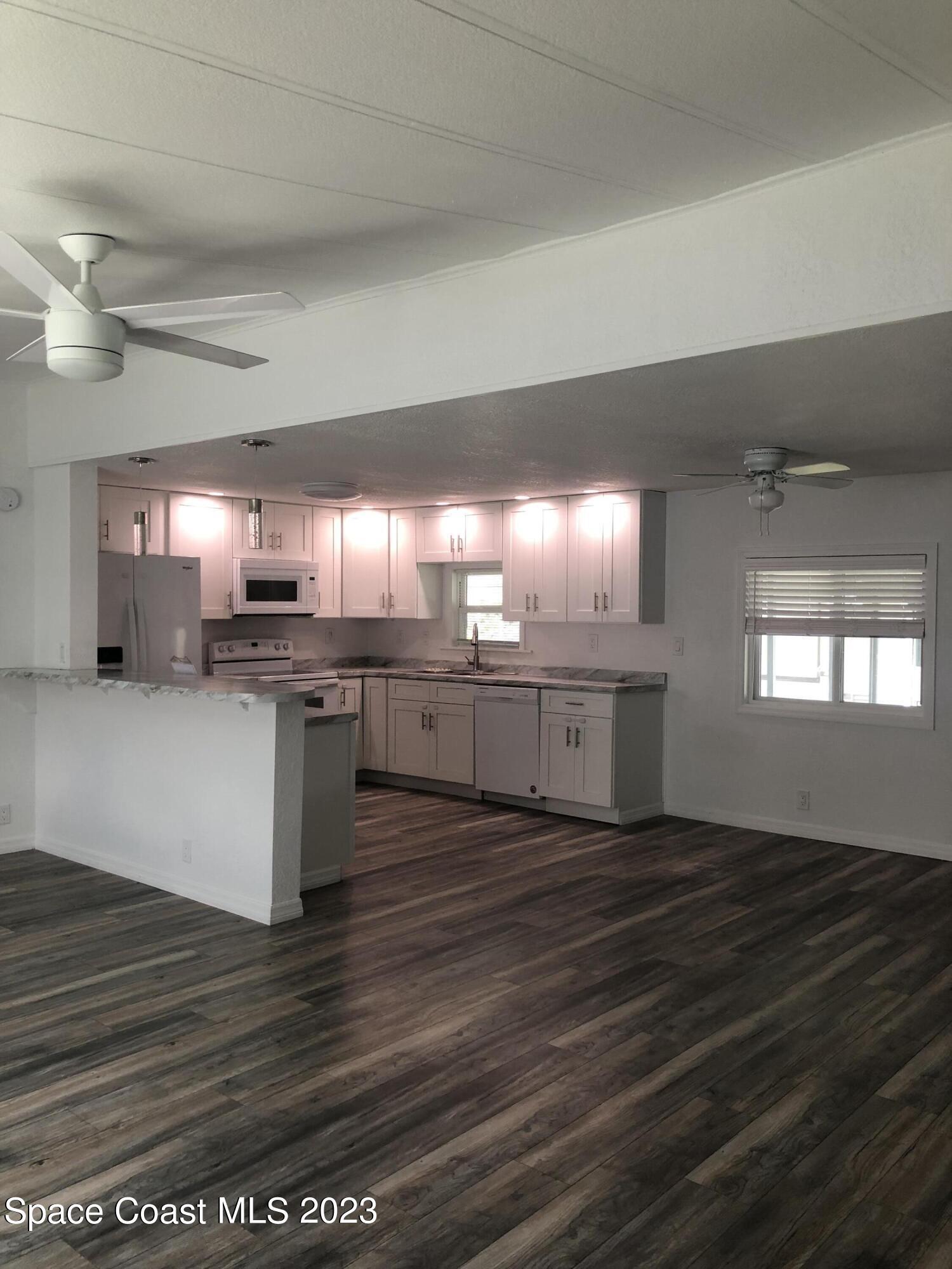 522 Egret Circle Sebastian, FL 32976 - Photo 3 of 14 a large kitchen with stainless steel appliances granite countertop a stove a sink and a dishwasher