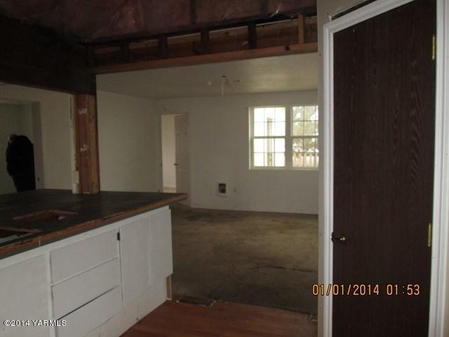 250 Knowles Road Granger, WA 98932 - Photo 3 of 8 a kitchen with a sink and cabinets