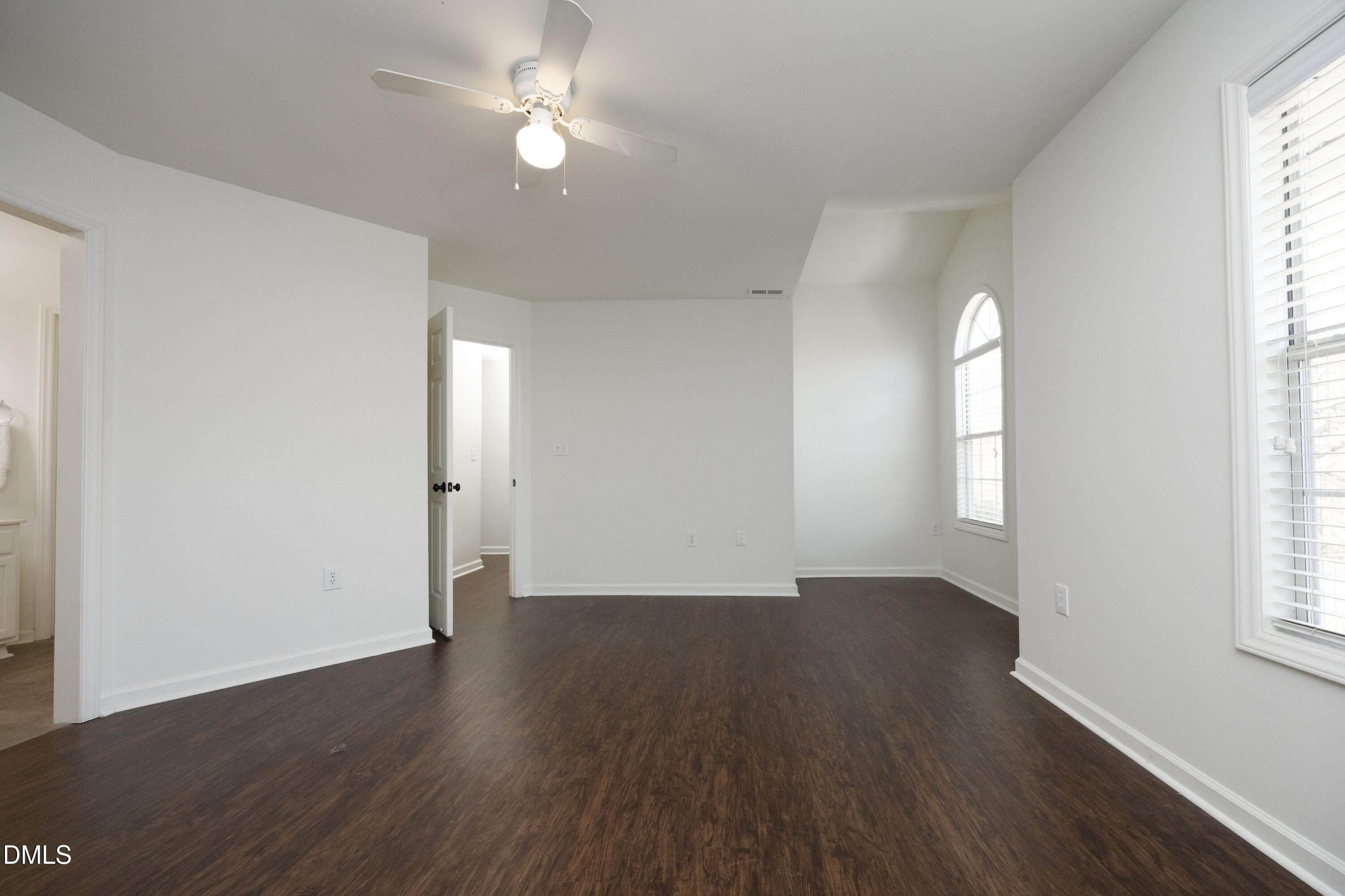 521 Renshaw Court Cary, NC 27518 - Photo 18 of 34 an empty room with wooden floor and windows