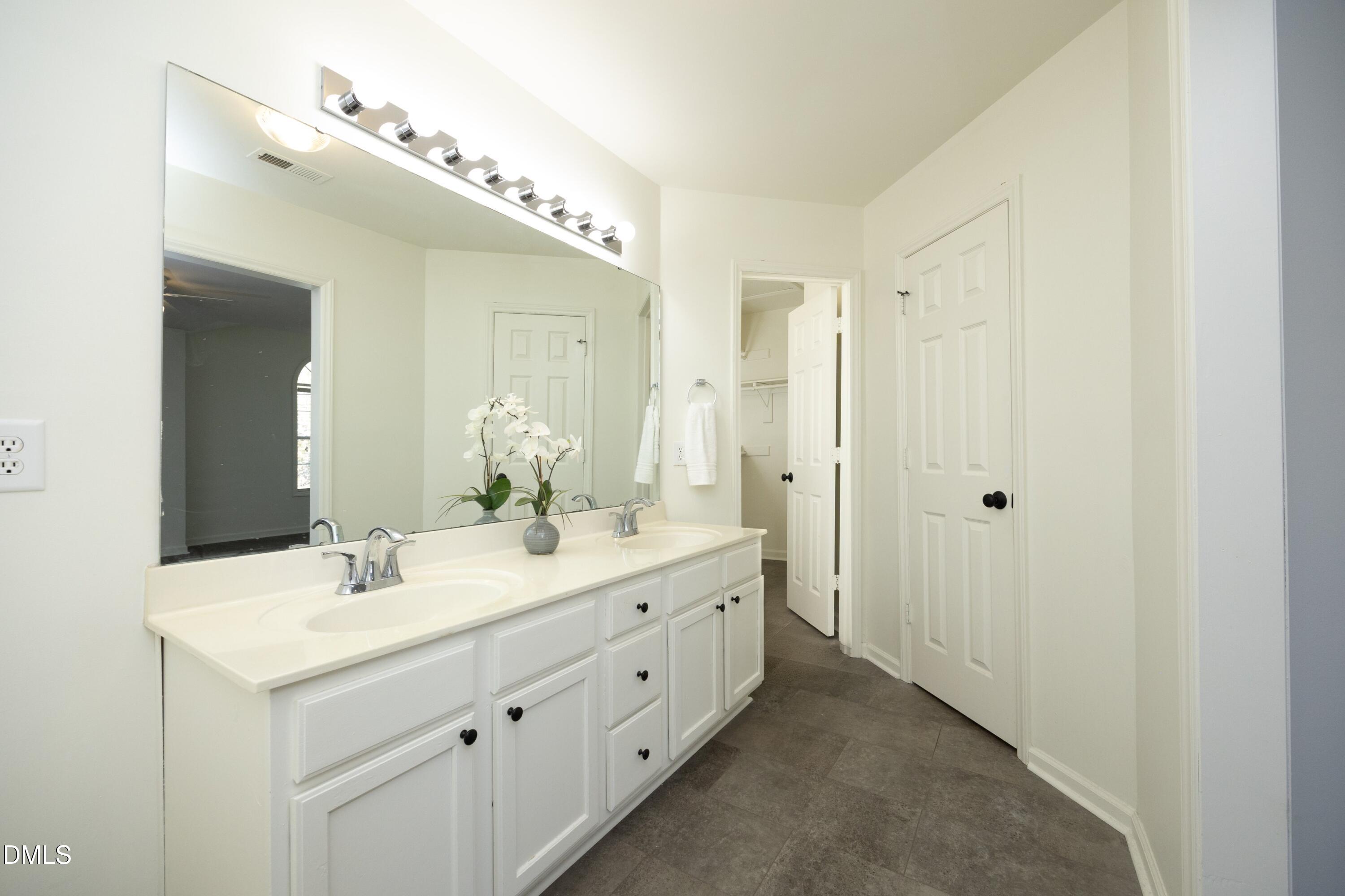 521 Renshaw Court Cary, NC 27518 - Photo 19 of 34 a bathroom with a double vanity sink mirror and