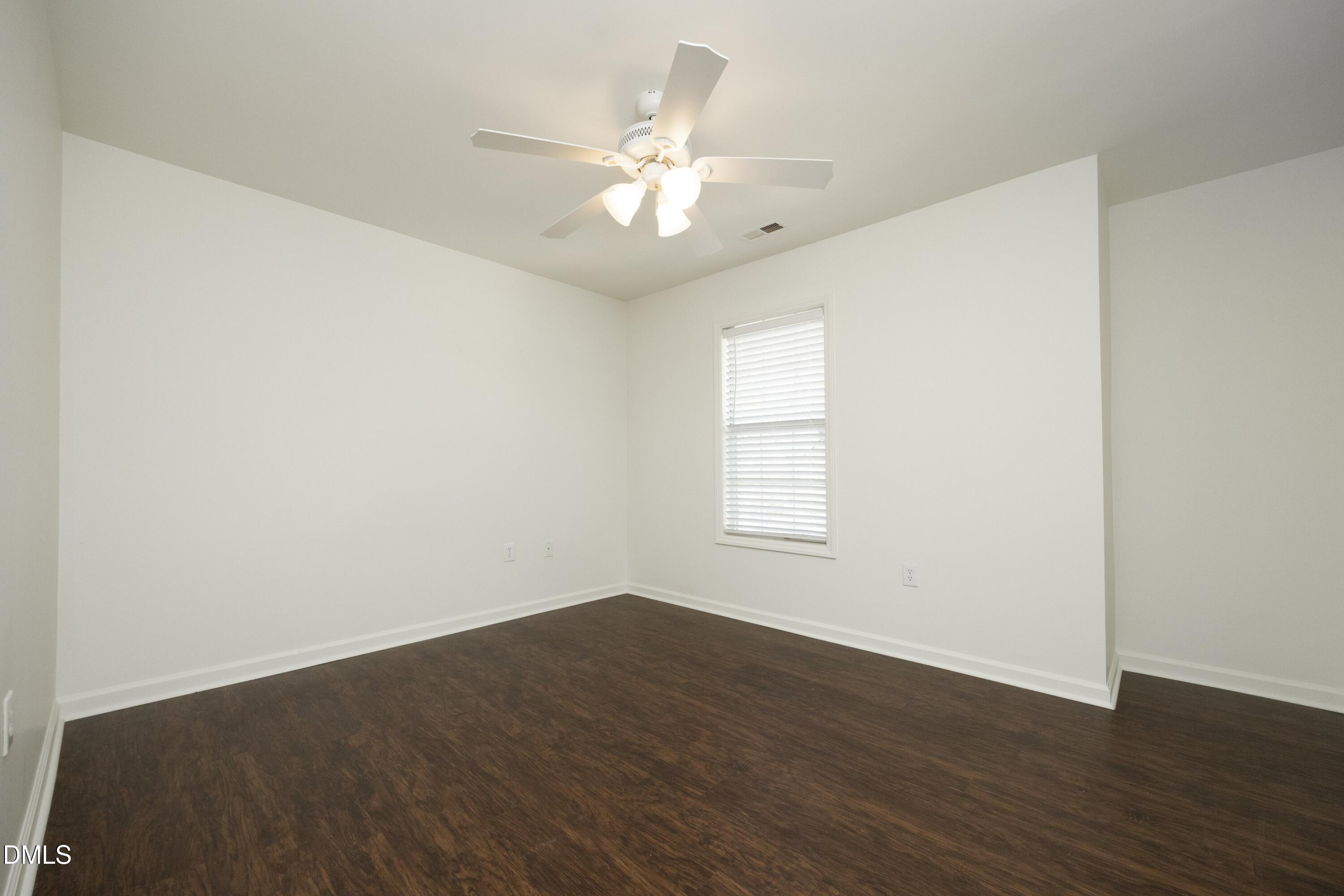 521 Renshaw Court Cary, NC 27518 - Photo 23 of 34 an empty room with wooden floor fan and windows