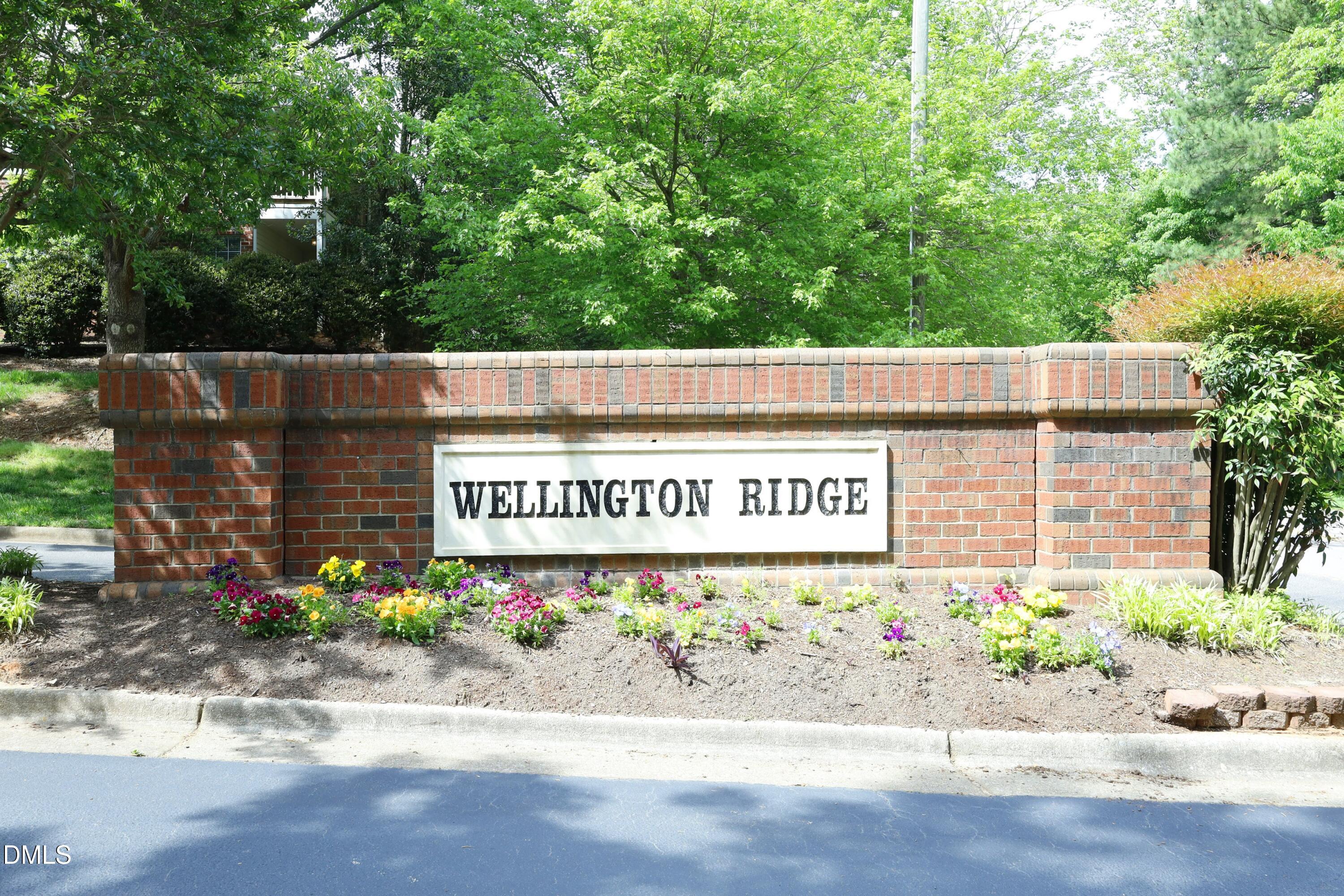 521 Renshaw Court Cary, NC 27518 - Photo 32 of 34 a wooden sign that is on the side of a road