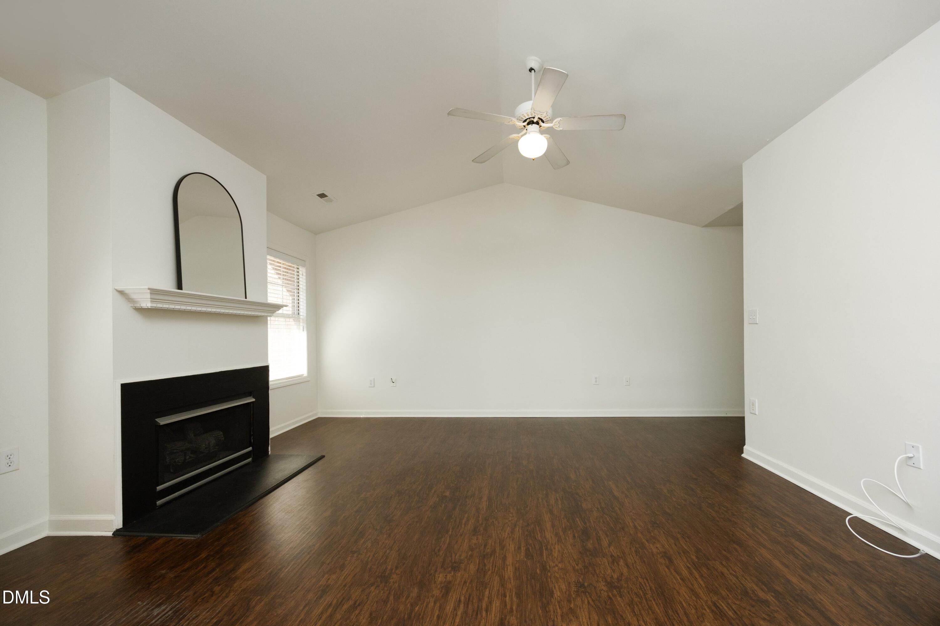521 Renshaw Court Cary, NC 27518 - Photo 8 of 34 a view of empty room with wooden floor and fireplace