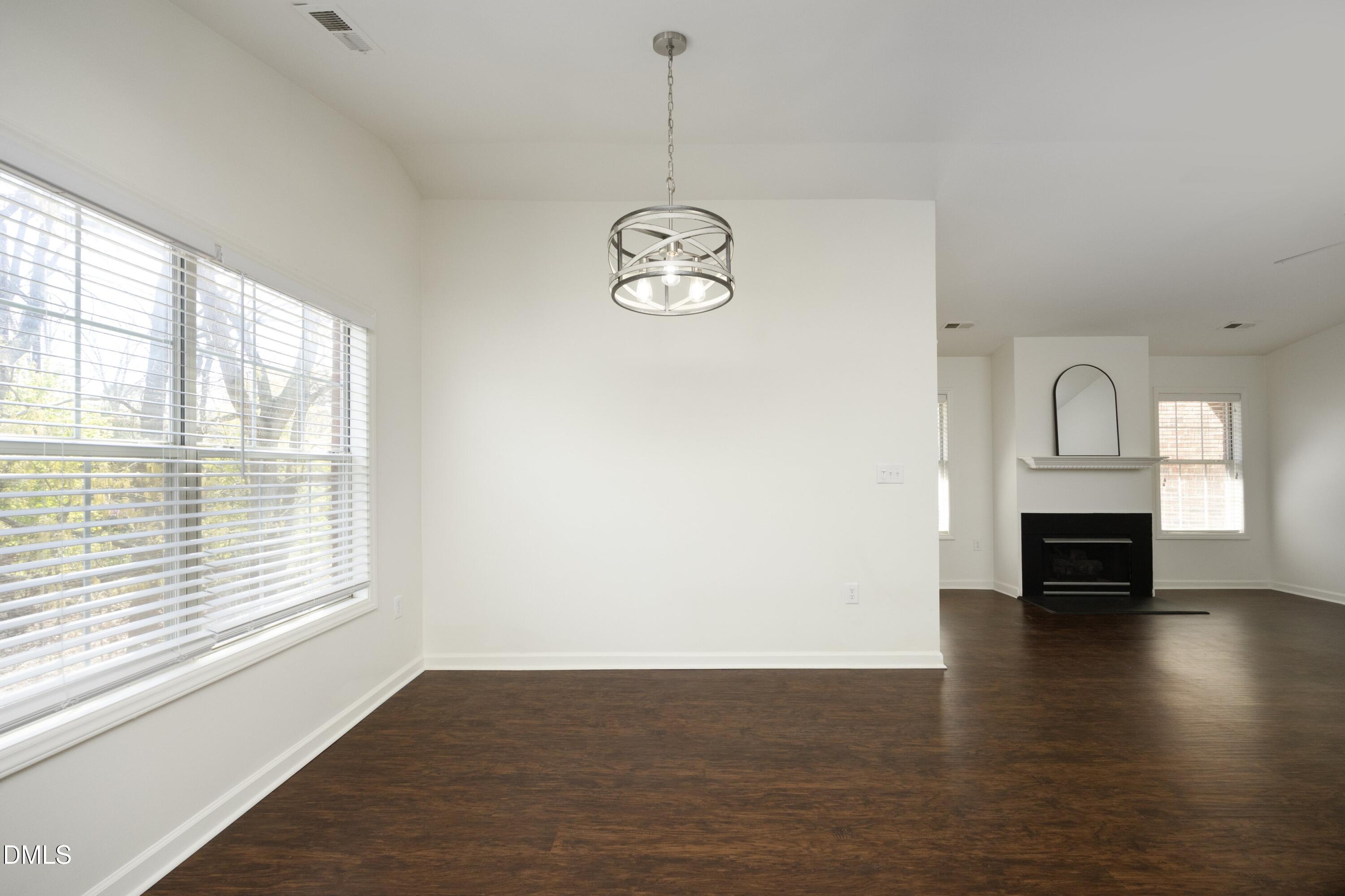 521 Renshaw Court Cary, NC 27518 - Photo 9 of 34 an empty room with wooden floor fan and windows