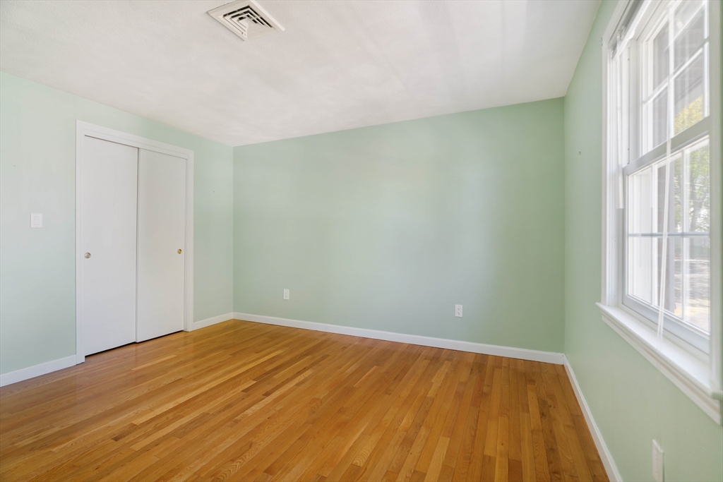 44 Salem Street, Unit C Wakefield, MA 01880 - Photo 16 of 26 a view of an empty room with wooden floor and a window